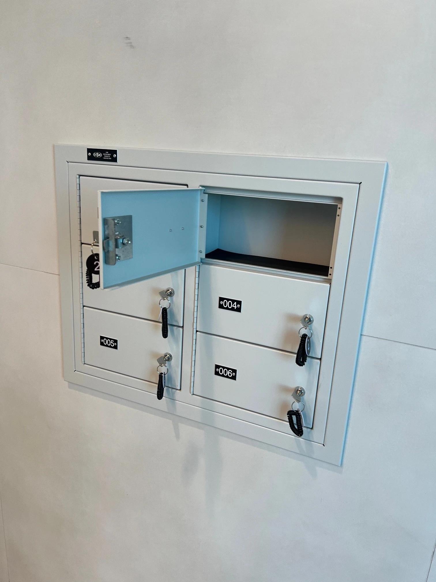 Wall-mounted gunmetal locker with a single door and compact storage compartment.